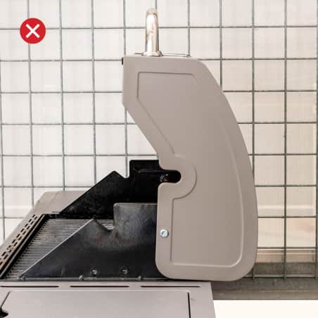 A gas grill with a curved lid standing open. 